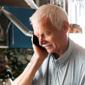 Plumbers Potts Point 38 concentrated elderly man with a phone in his hands